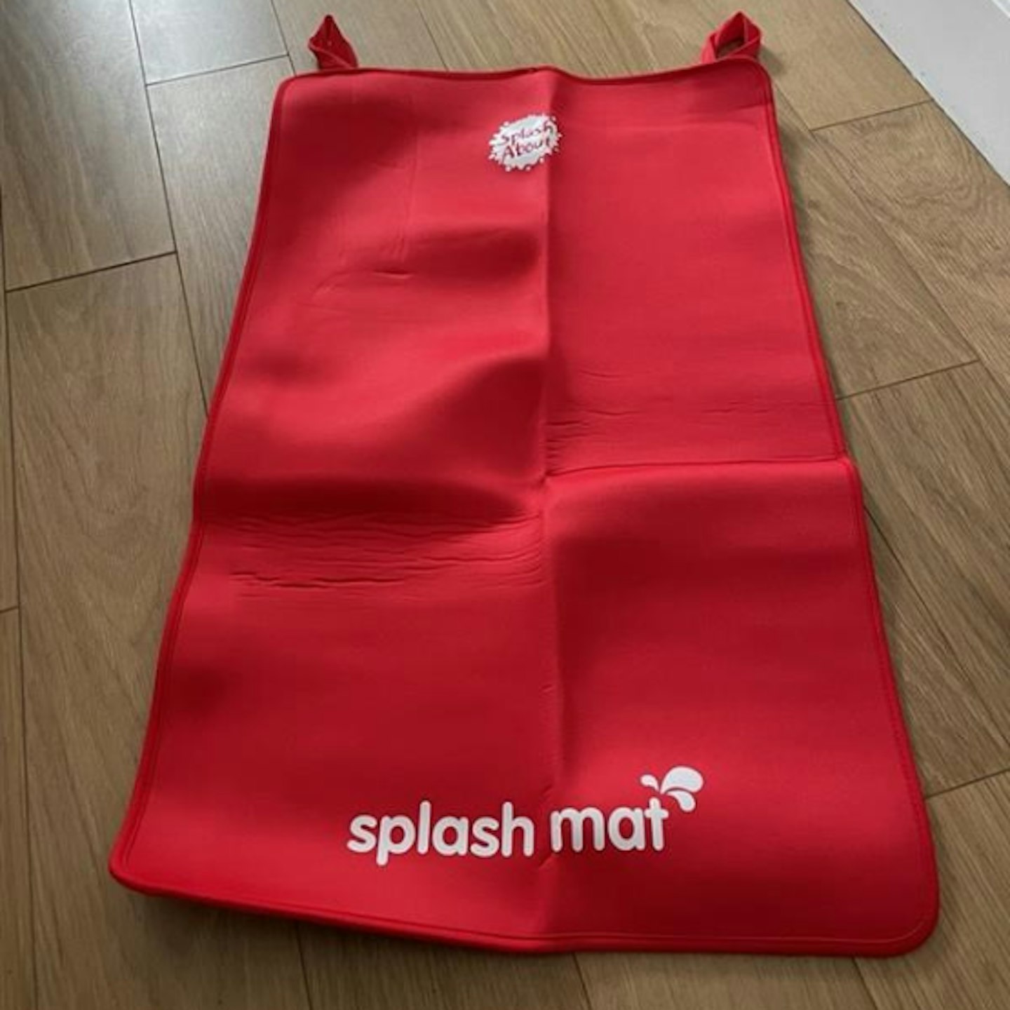 Splash About Baby Neoprene Changing in red spread opened on the floorMat 