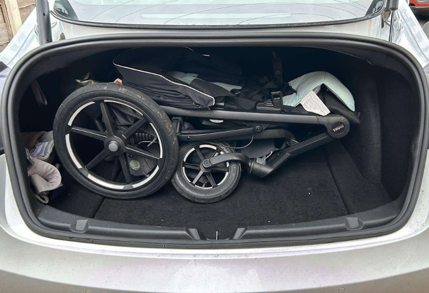 Thule urban glide 3 folded down in a car boot