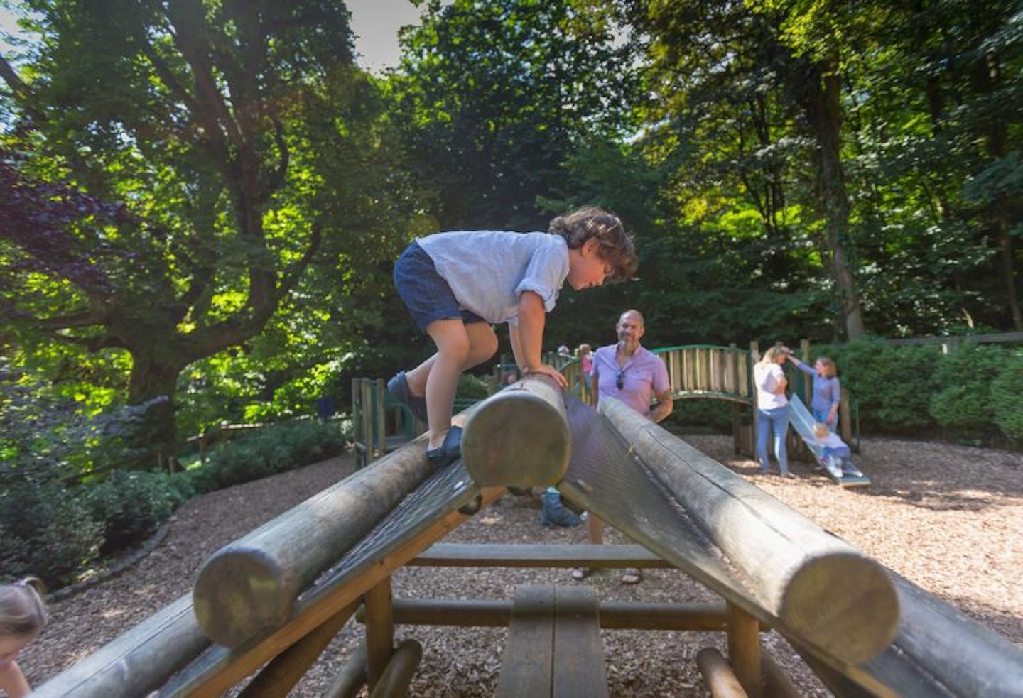 Child claiming on woodland playground at National Trust Waddesdon Manor