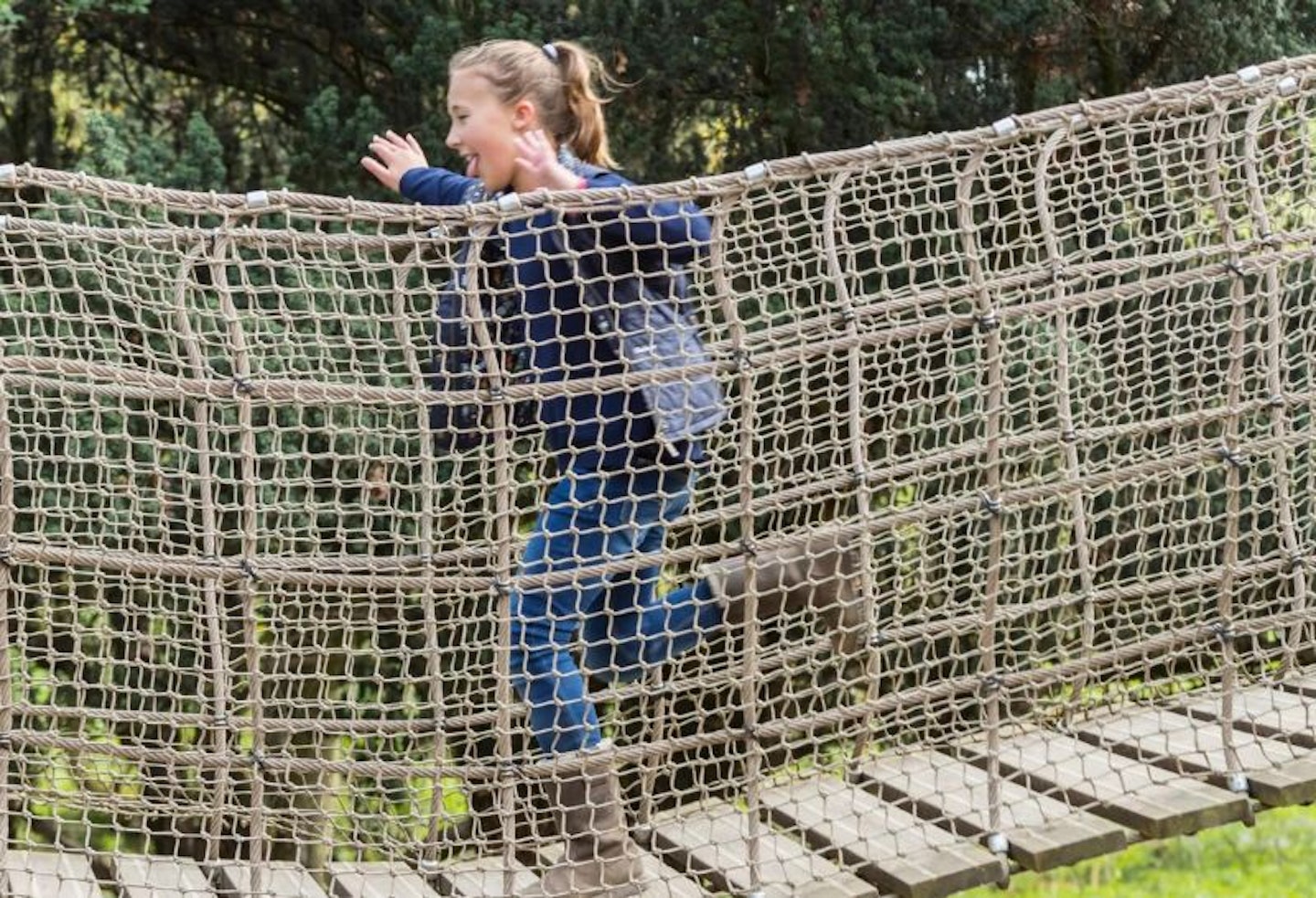 Girl on the rope bridge at Belton Estate Adventure Playground