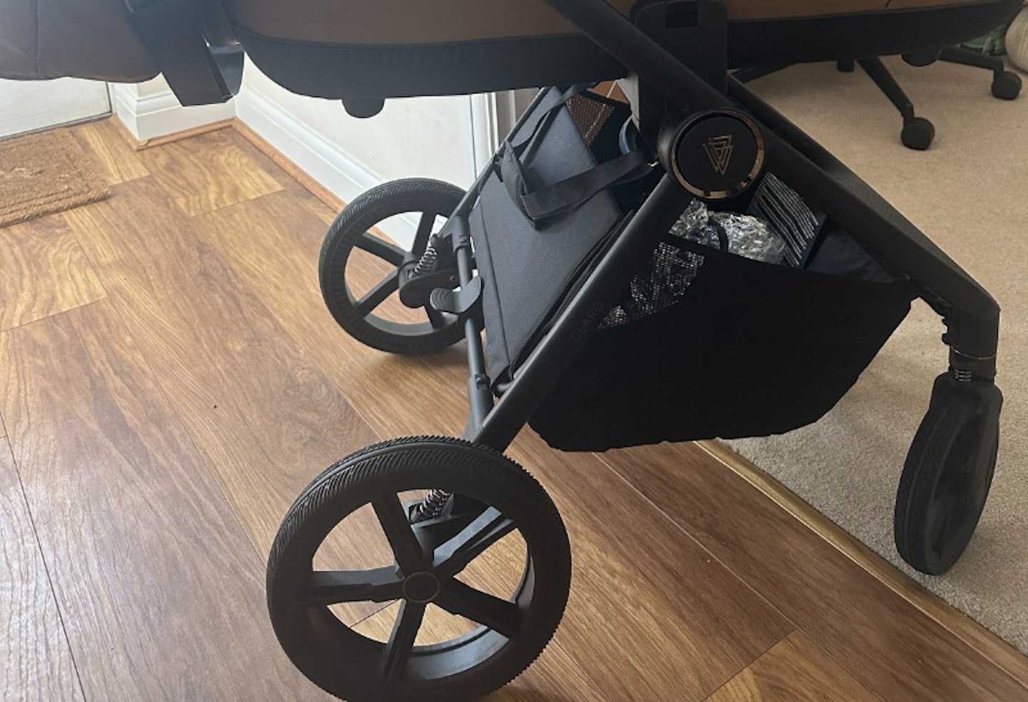 wheel details and bottom basket on the Venicci Claro 3-in-1 plus travel system