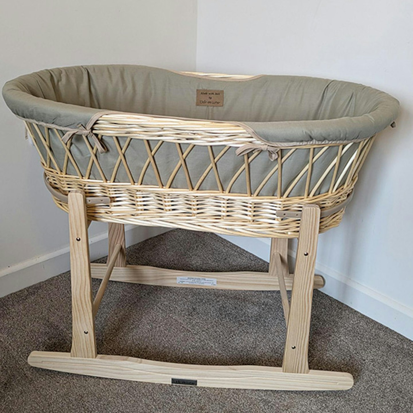 Clair de Lune Organic Natural Wicker Moses Basket with rocking stand in corner of a room