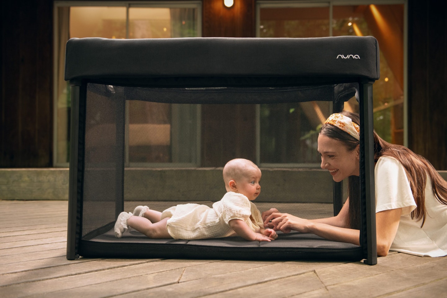 Mum and baby in Nuna PAAL travel cot