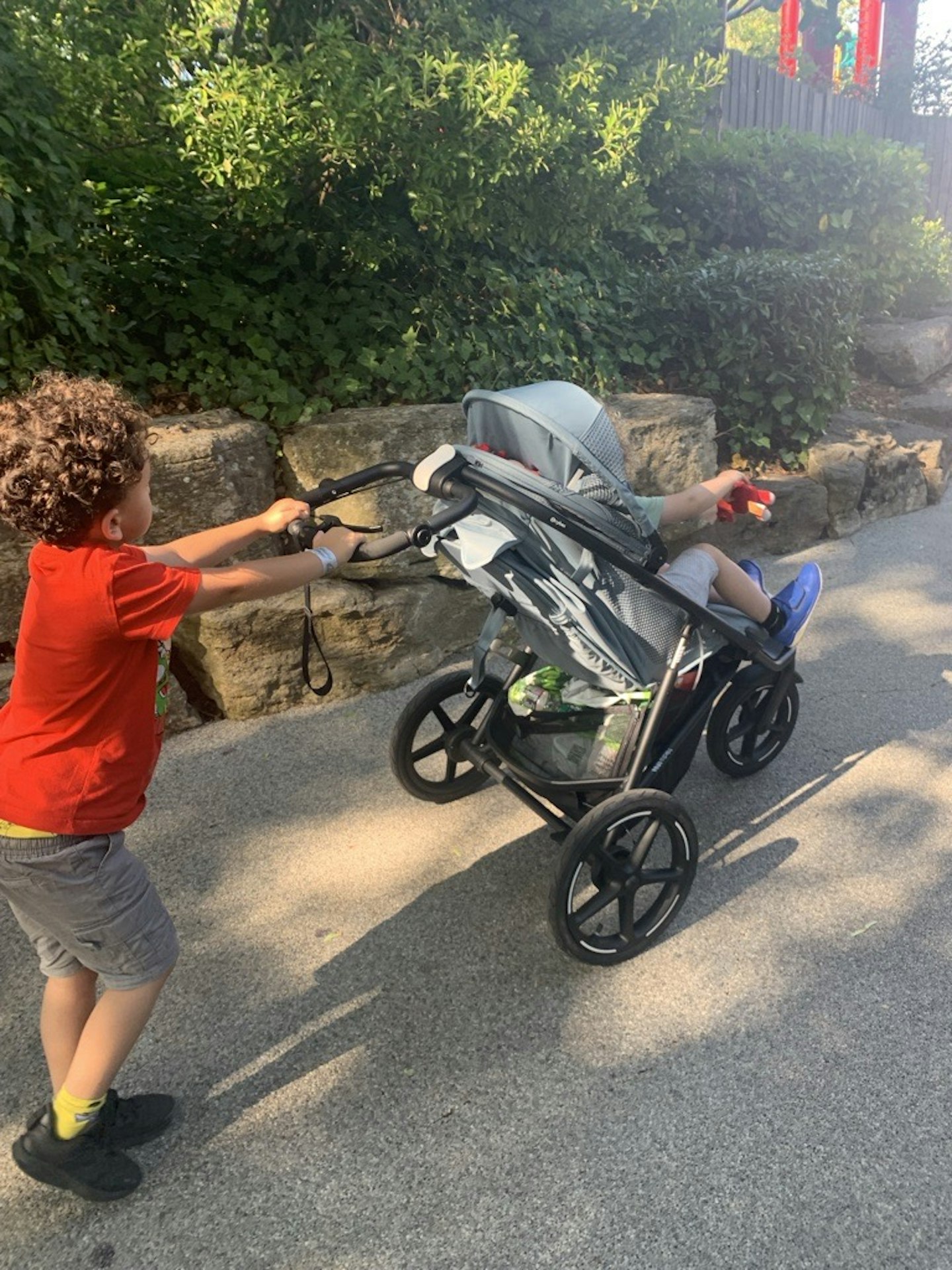 Six-year-old George pushing his brother Harry in the Cybex Avi Spin