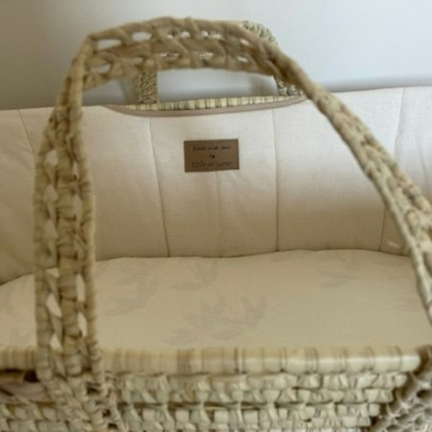 Clair de Lune Organic Palm Moses Basket with mattress inside and showing integrated handles