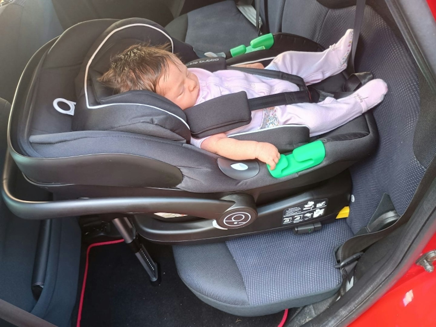 Baby sleeping in the car seat of the Ickle Bubba Altima travel system