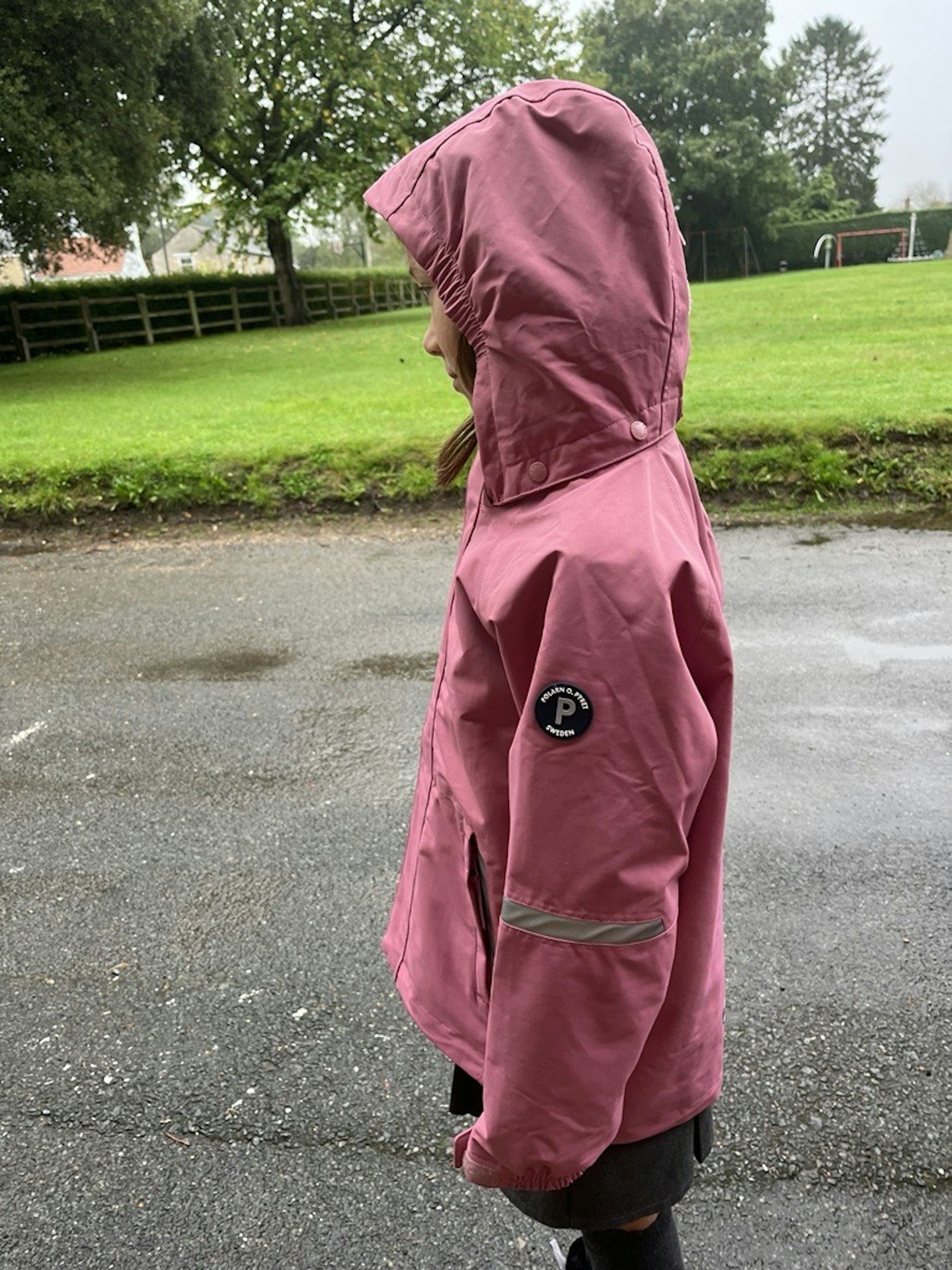 A side view of a child wearing the PO.P Waterproof School Coat