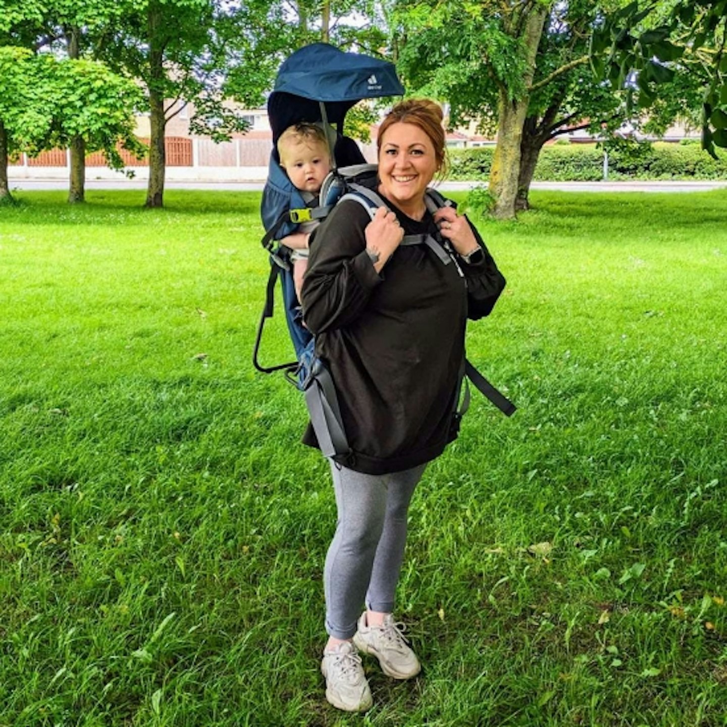 a mum wearing the parent wearing the Kids Baby Carrier Deuter Comfort Plus with their baby in it