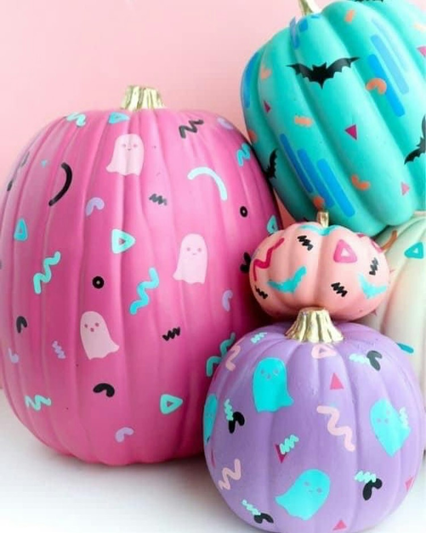 Pumpkins painted in pastel colours with cute ghosts