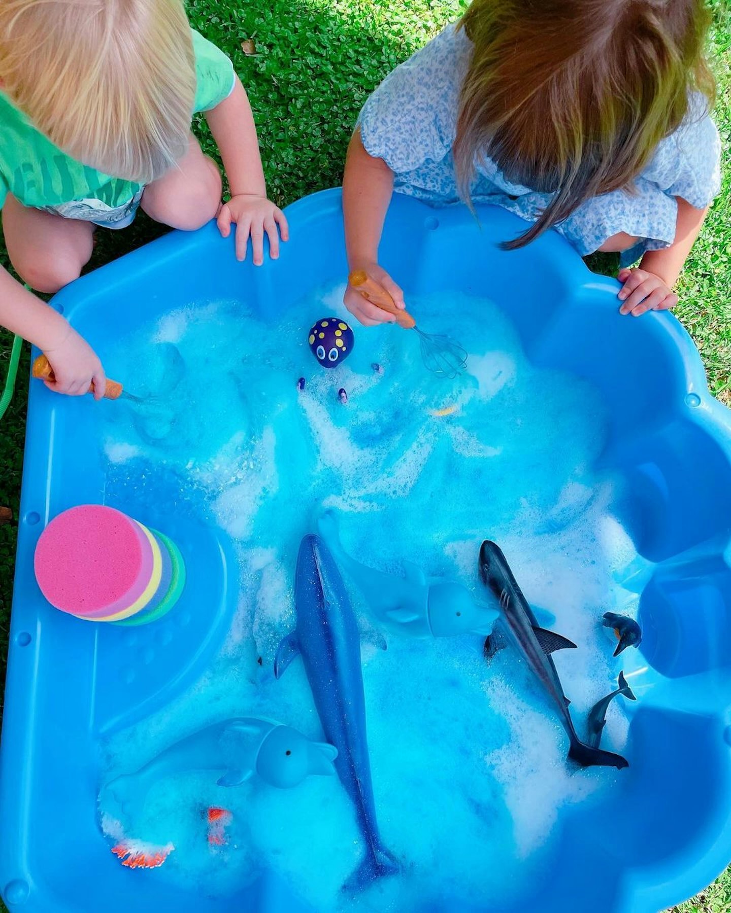 Children enjoying sensory play with soapy sea foam