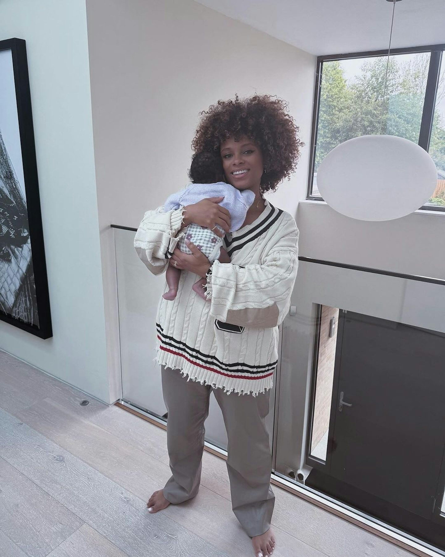Fleur East standing with her daughter Nova