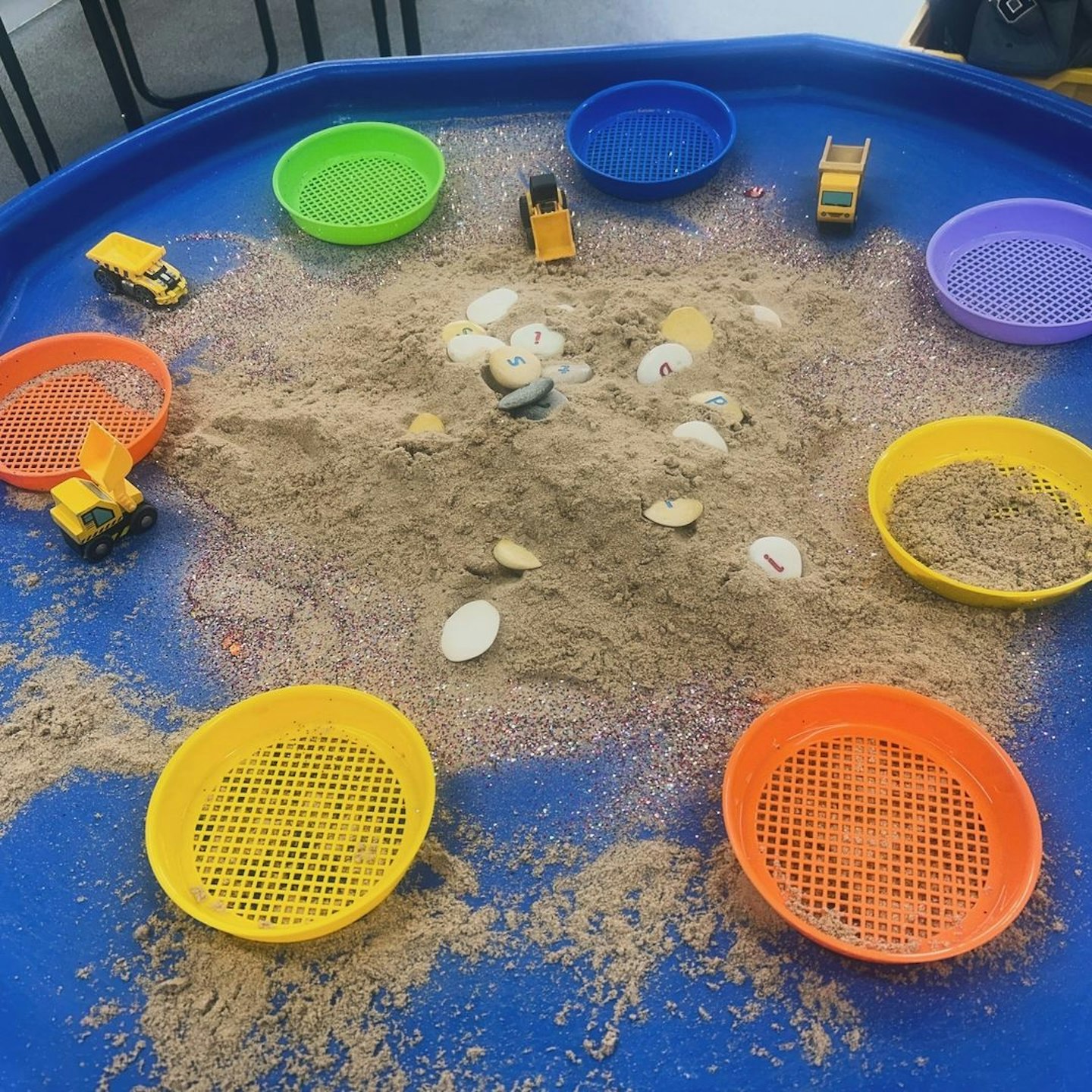 Tuff tray with sand and sieves for sensory play