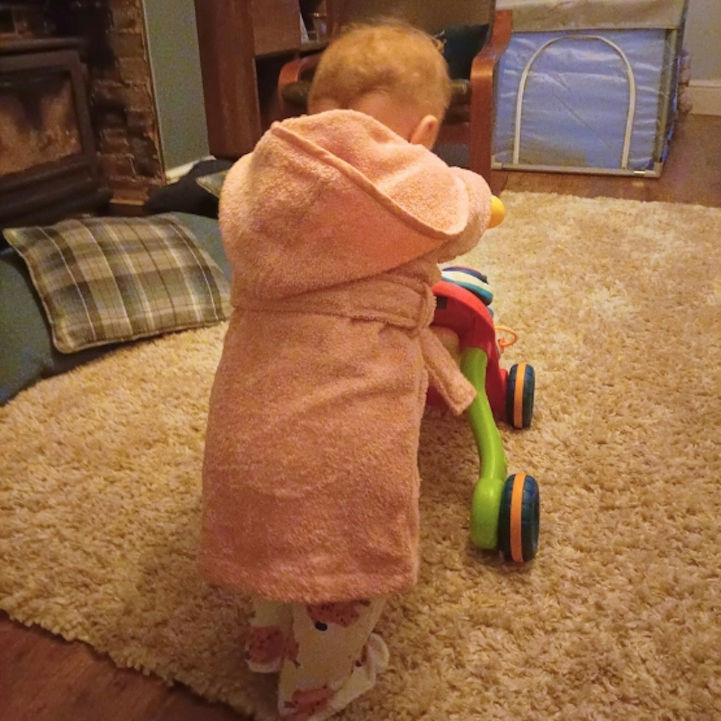 young child walking with the Stone Sit-to-Stand Learning Walker