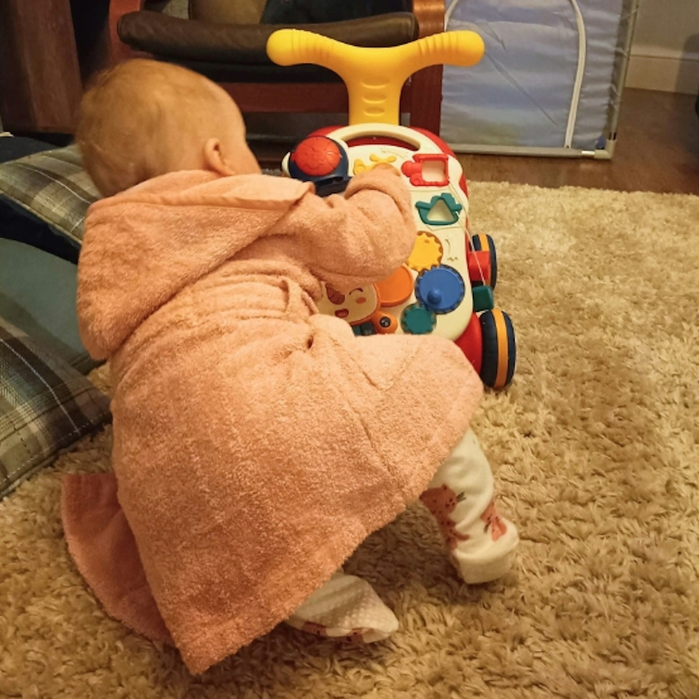 young child playing with the Stone Sit-to-Stand Learning Walker