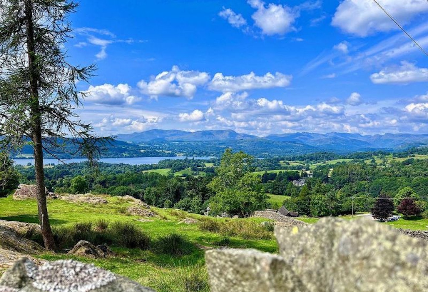 Hills and lakes of the Lake District with a dry stone wall in front