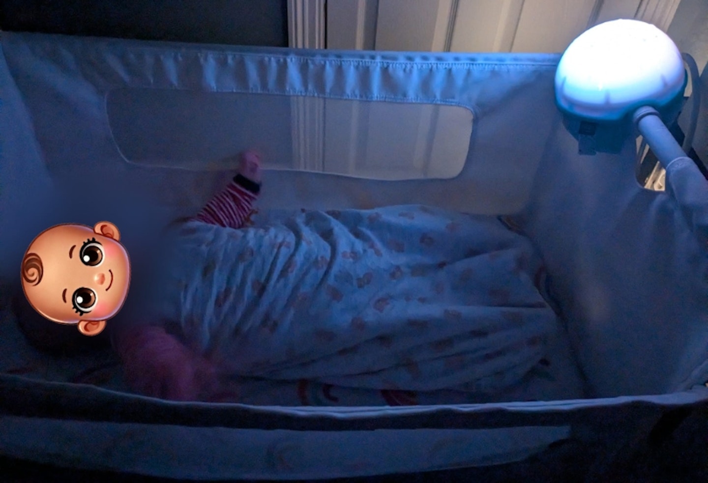 baby in the cot with the Chicco Next2 Stars Night Light Projector attached