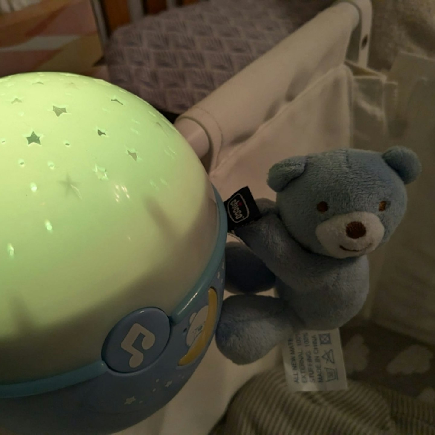 Chicco Next2 Stars Night Light Projector with toy attached to the cot