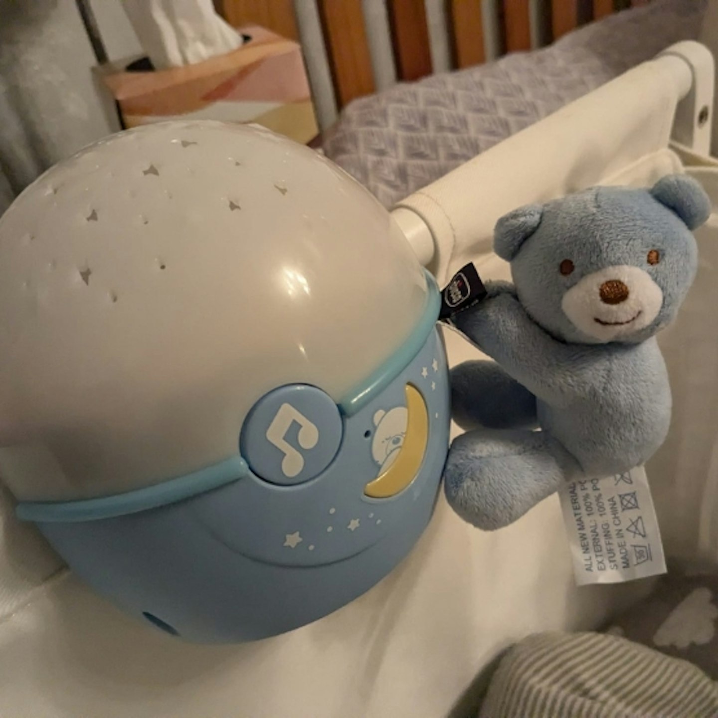 Chicco Next2 Stars Night Light Projector with toy attached to the cot