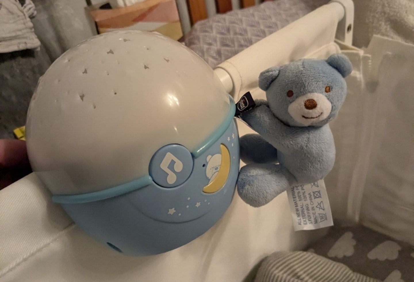 Chicco Next2 Stars Night Light Projector with toy attached to the cot