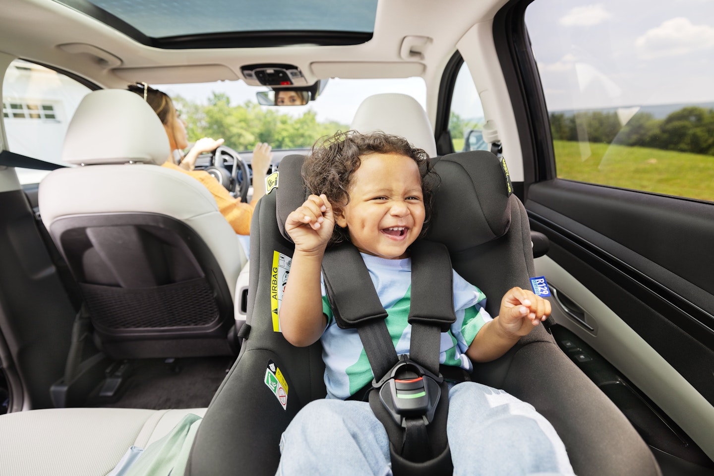 Toddler laughing in Graco car seat
