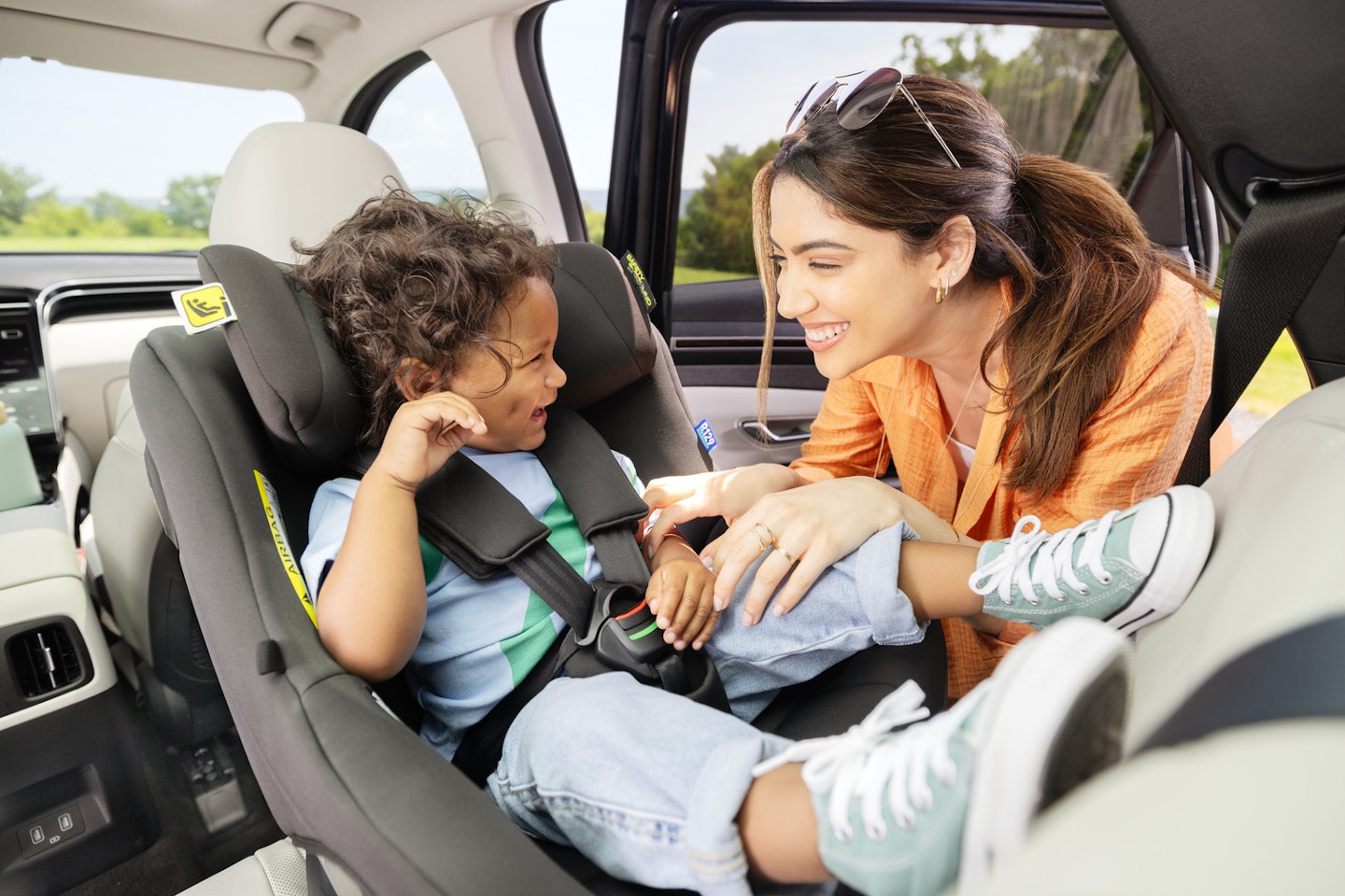 Woman smiling at toddler in Graco car seat