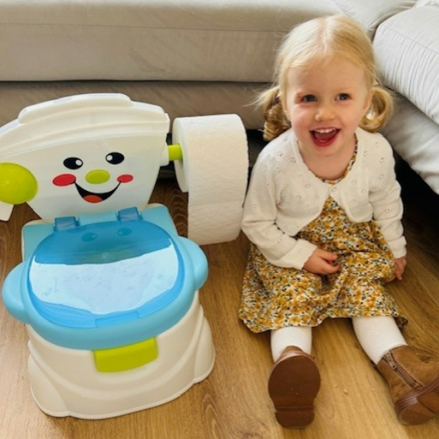 young girl sat next to the SA Products Kids Potty Training Toilet Seat with Splash Guard