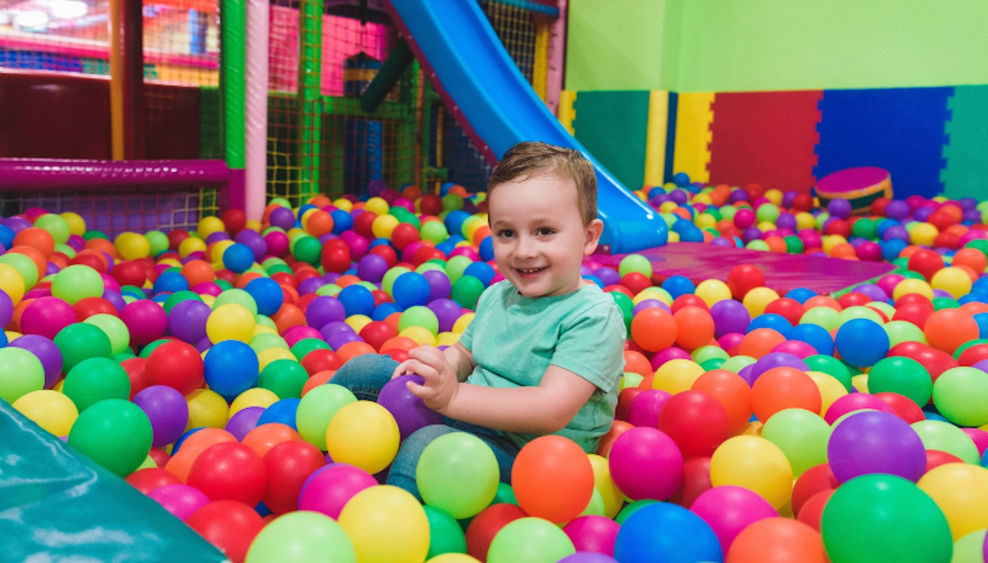 Child on the playground with colored plastic balls Child on the playground with colored plastic balls
