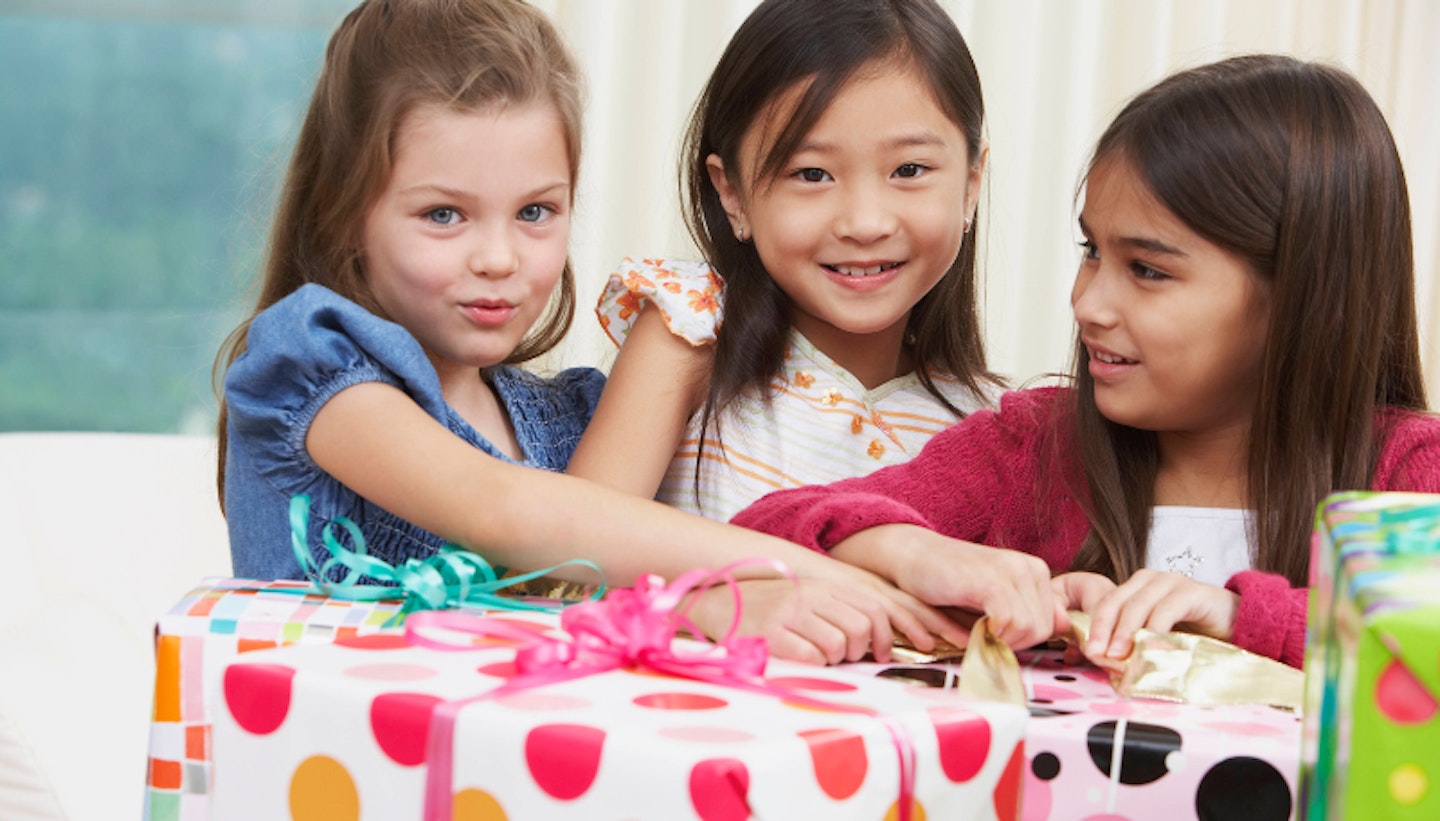 Group of young girls opening gifts