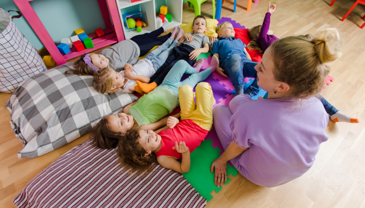 group of pre schoolers lying down in a nursery