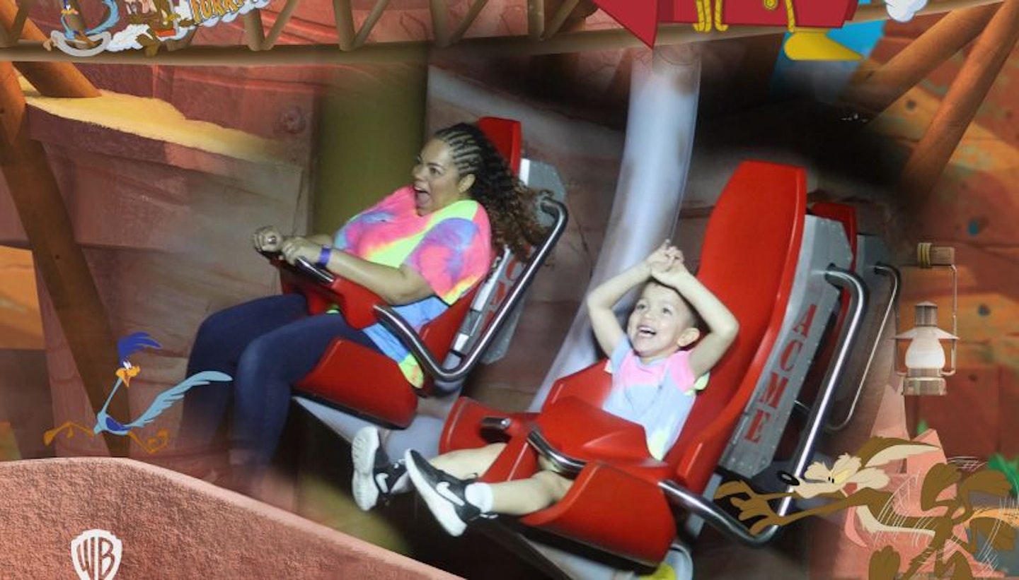 Senior Digital Writer Hannah Carroll and her son Frank riding a roller coaster in Warner Bros. World.