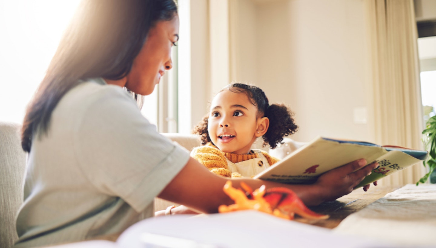 mother with a child for reading, teaching and support with homework. Family, house and a mom and girl kid learning knowledge from a book and studying together