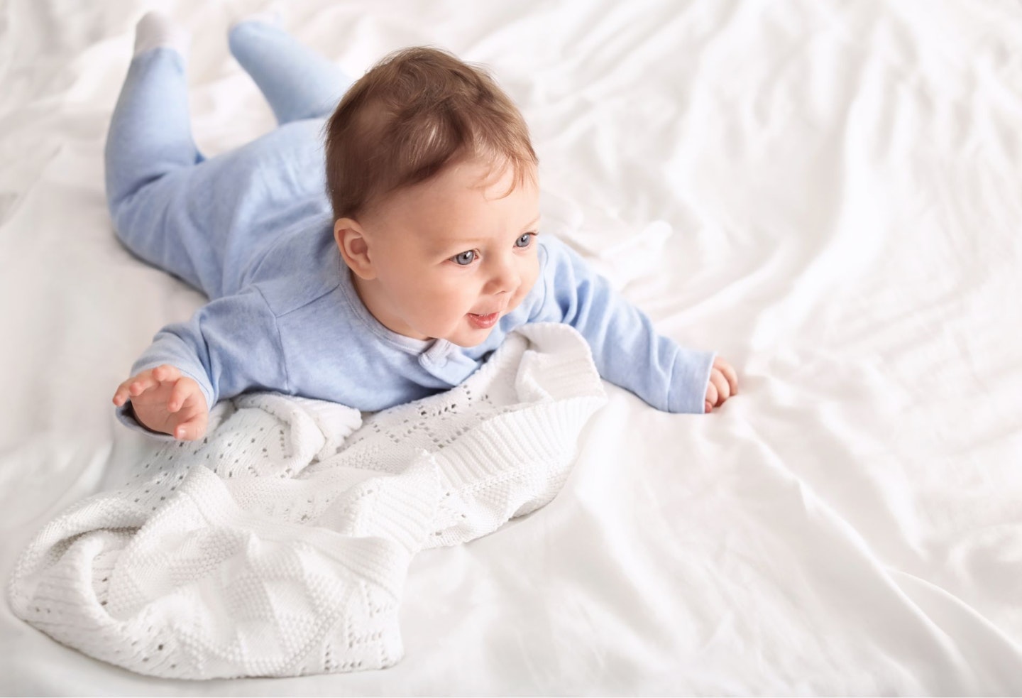 Cute Little Baby in Tummy Time on Bed