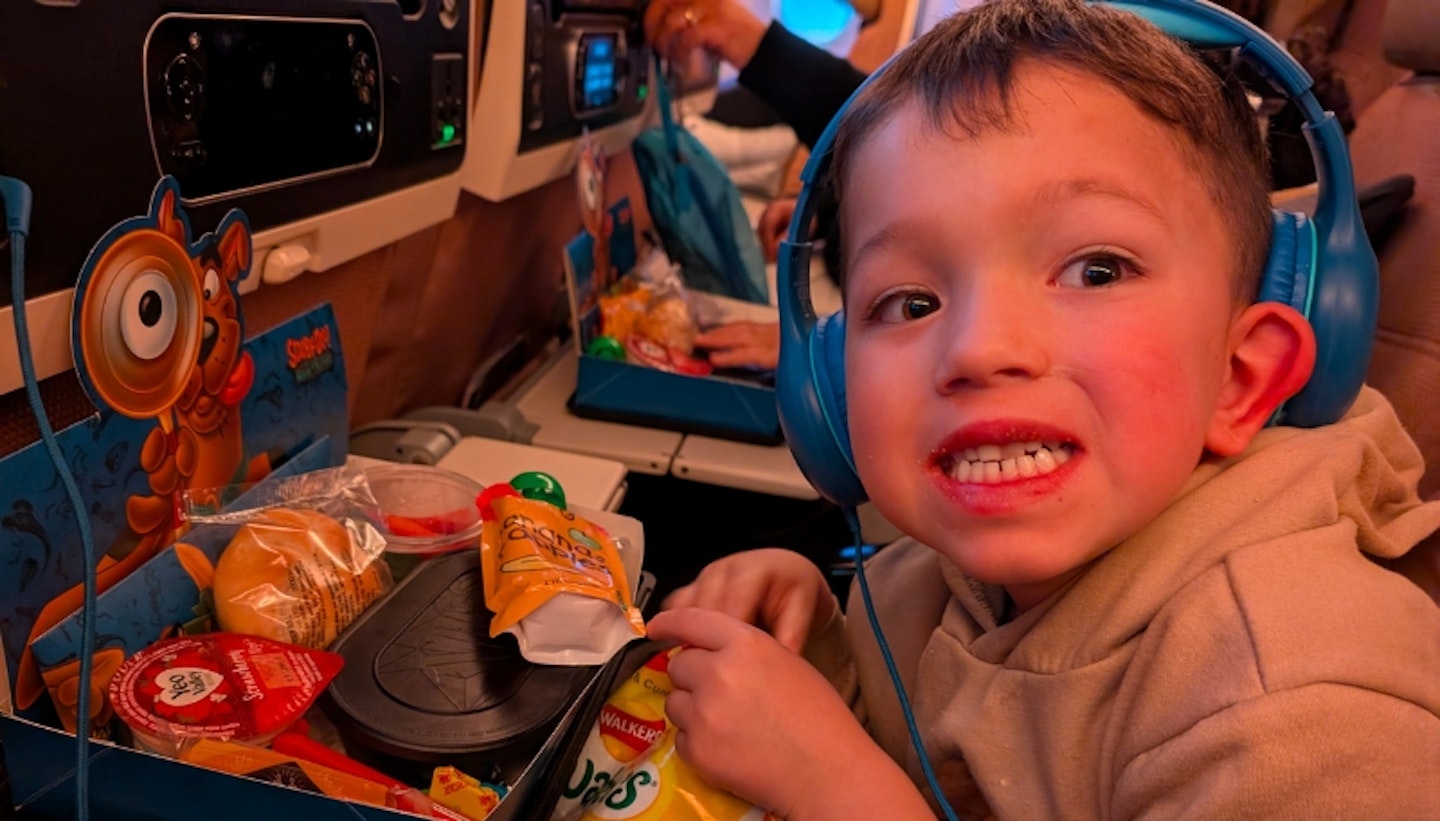 Little boy flying on Eithad Airways.