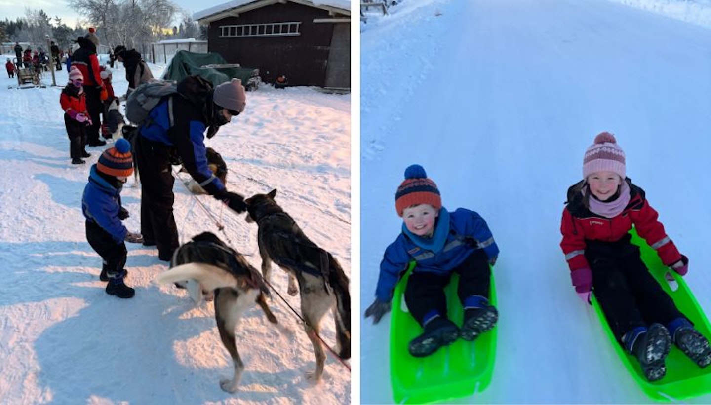 Image of two children tobogganing and huskys being fussed over