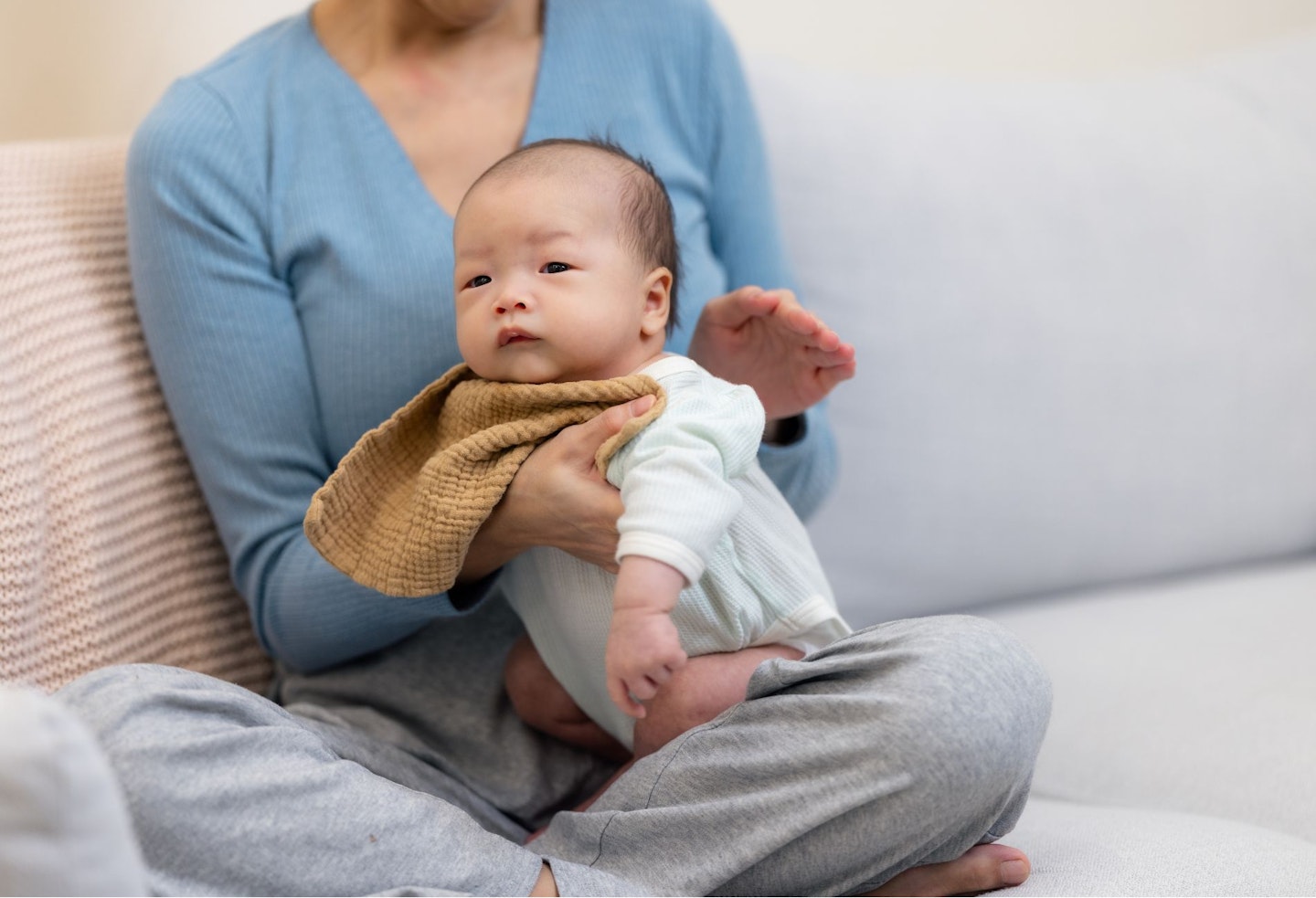 Mother helping baby to burp