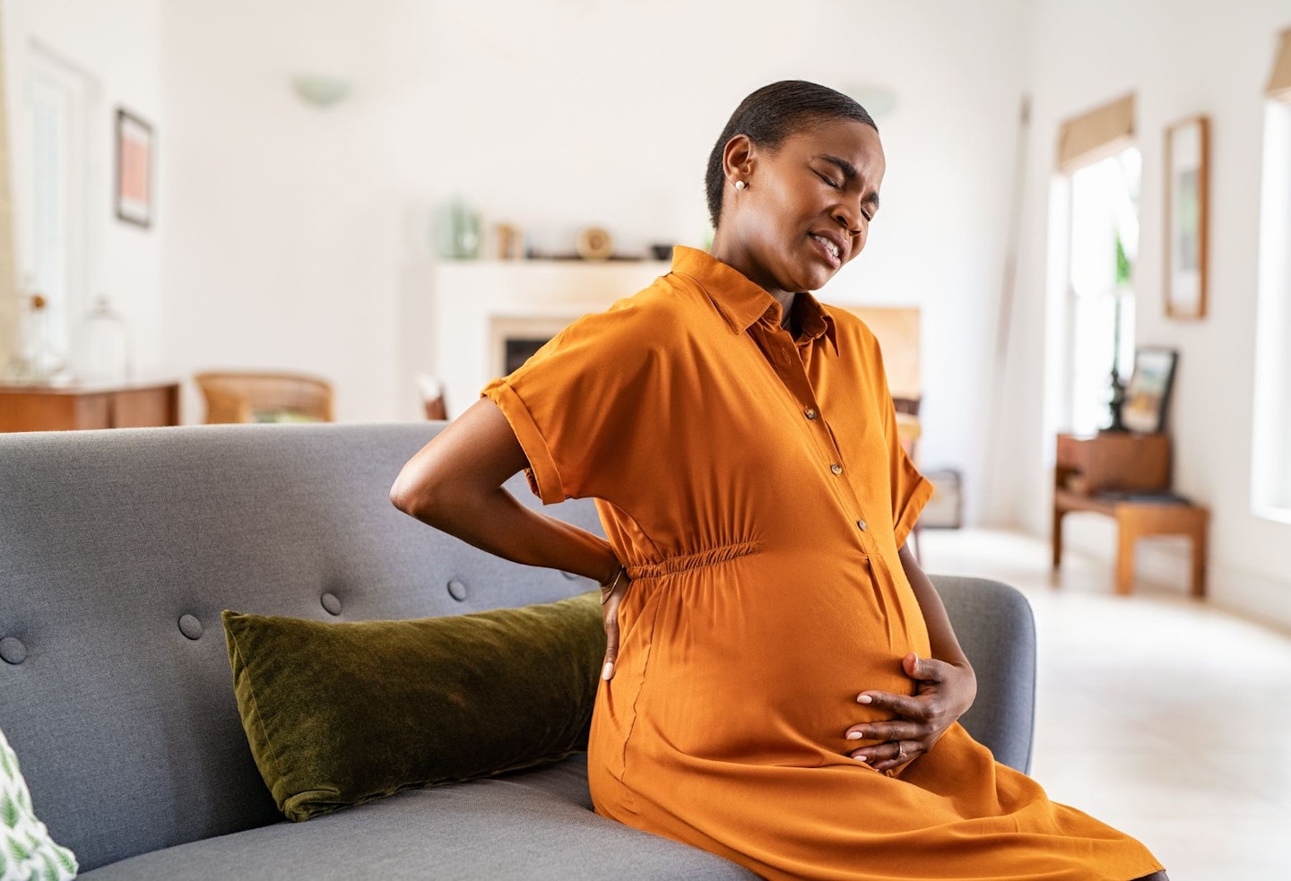 Pregnant Woman Having Backache in the Couch