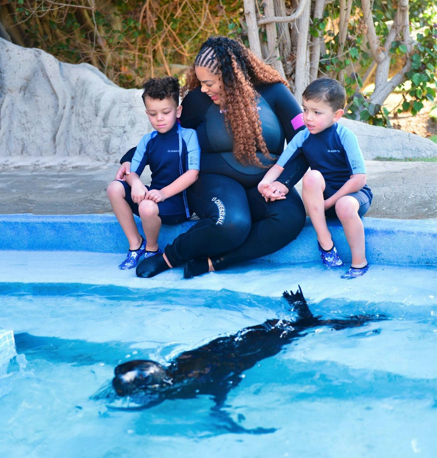 Senior digital writer, Hannah Carroll and her sons enjoying a sea lion experience with a sea lion in the water.