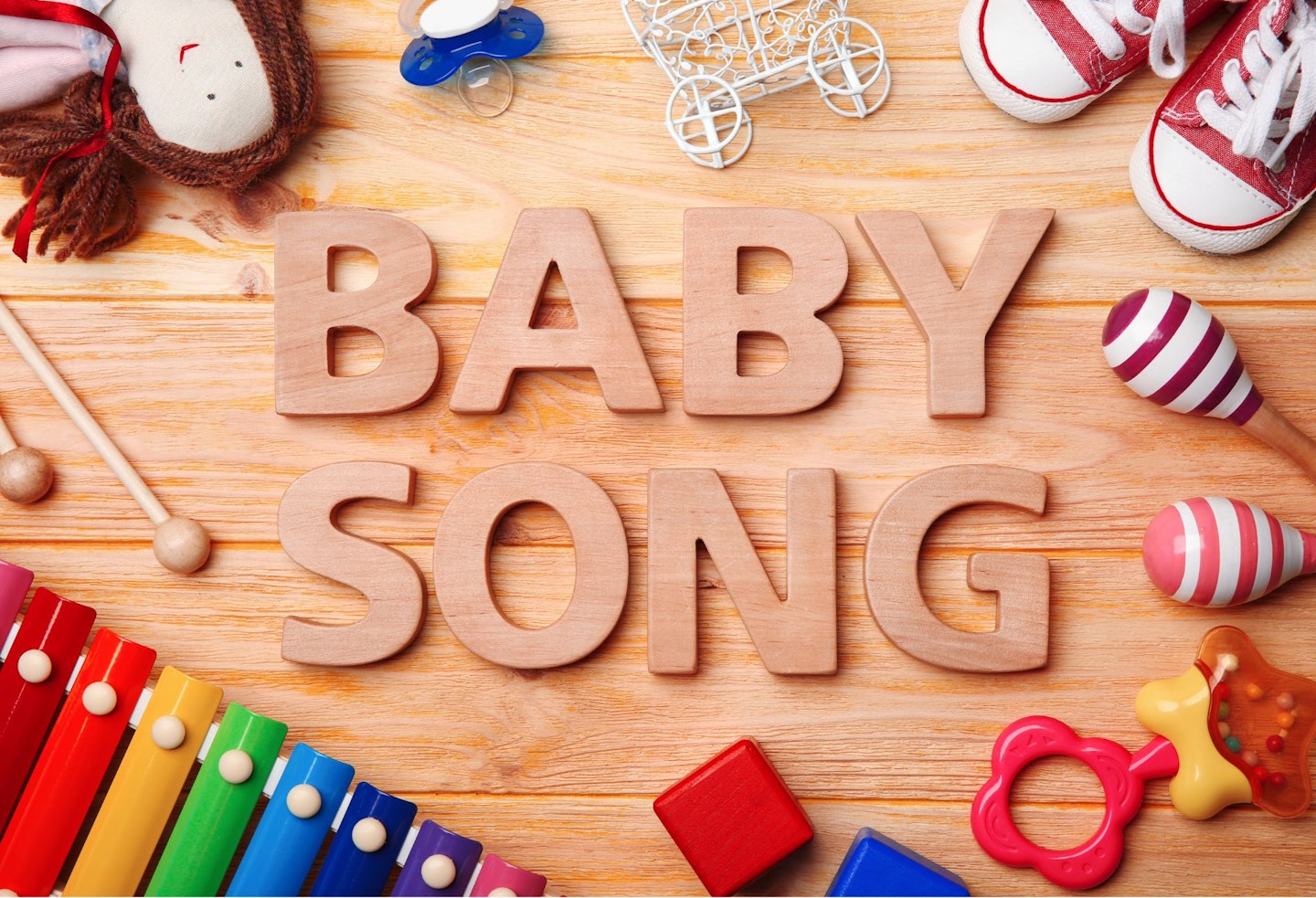 Text BABY SONG and Toys on Wooden Background