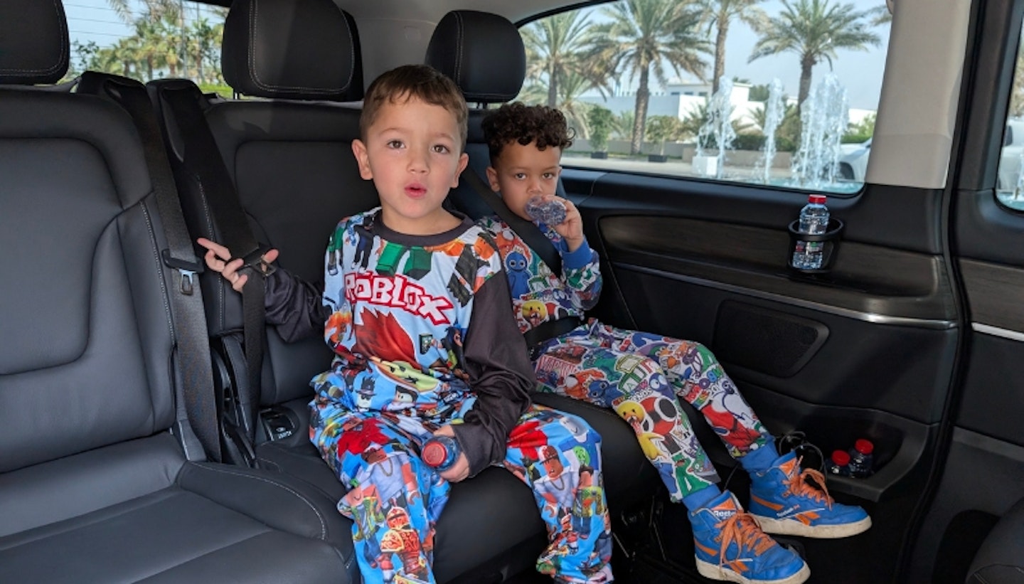 Two little boys travelling around in Abu Dhabi in their private car.