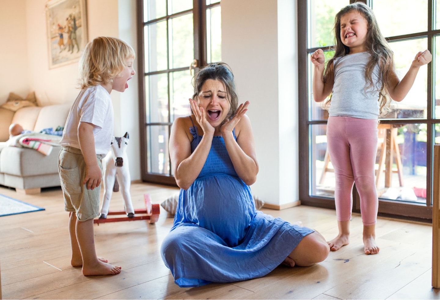 Unhappy Pregnant Woman with Screaming Children at Home