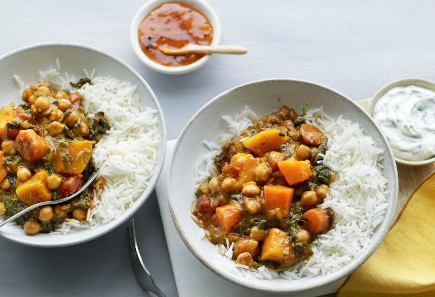 Two bowls of vegetable slow cooker curry with rice