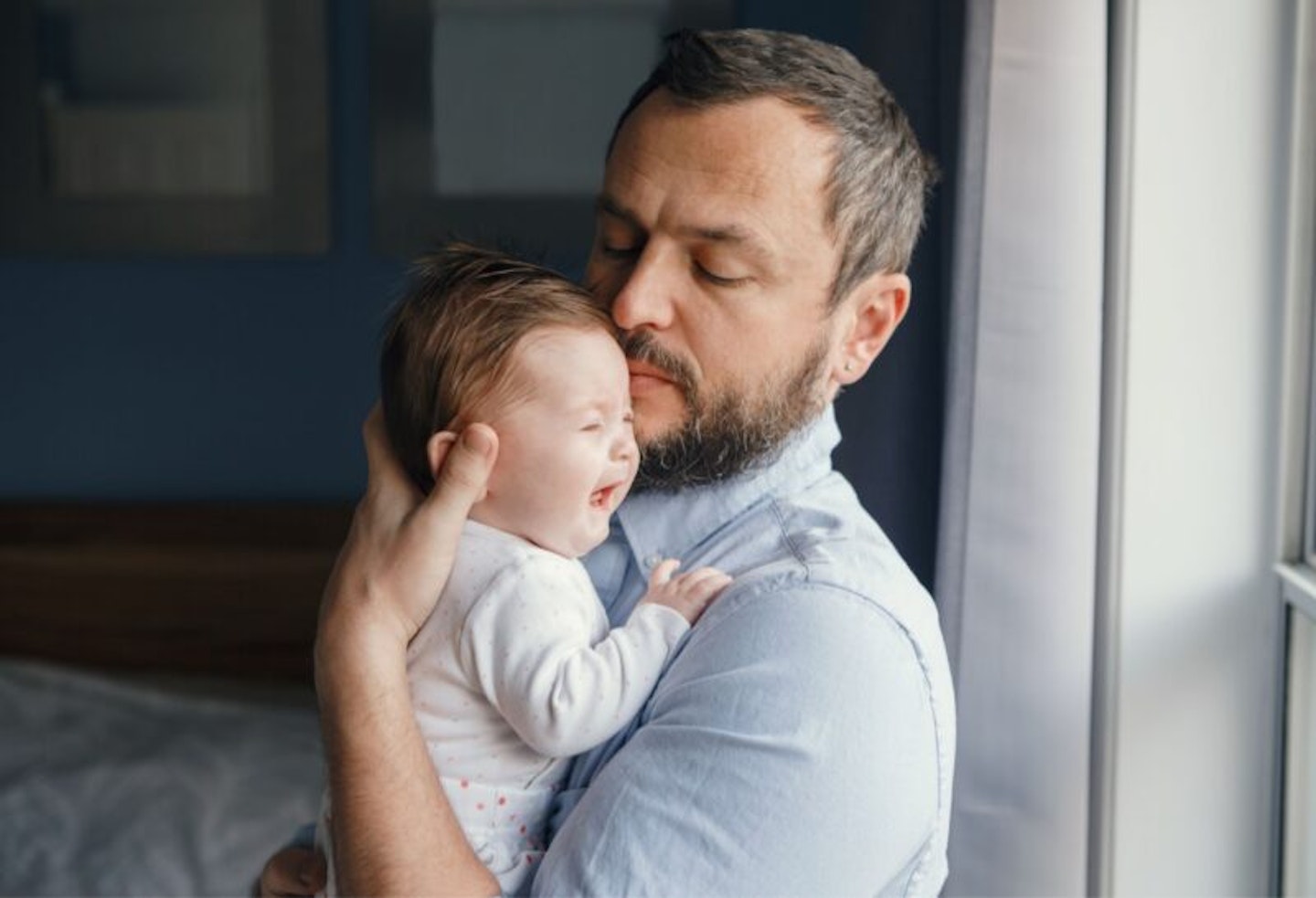 Middle Age Caucasian Father Trying to Calm down Newborn Baby