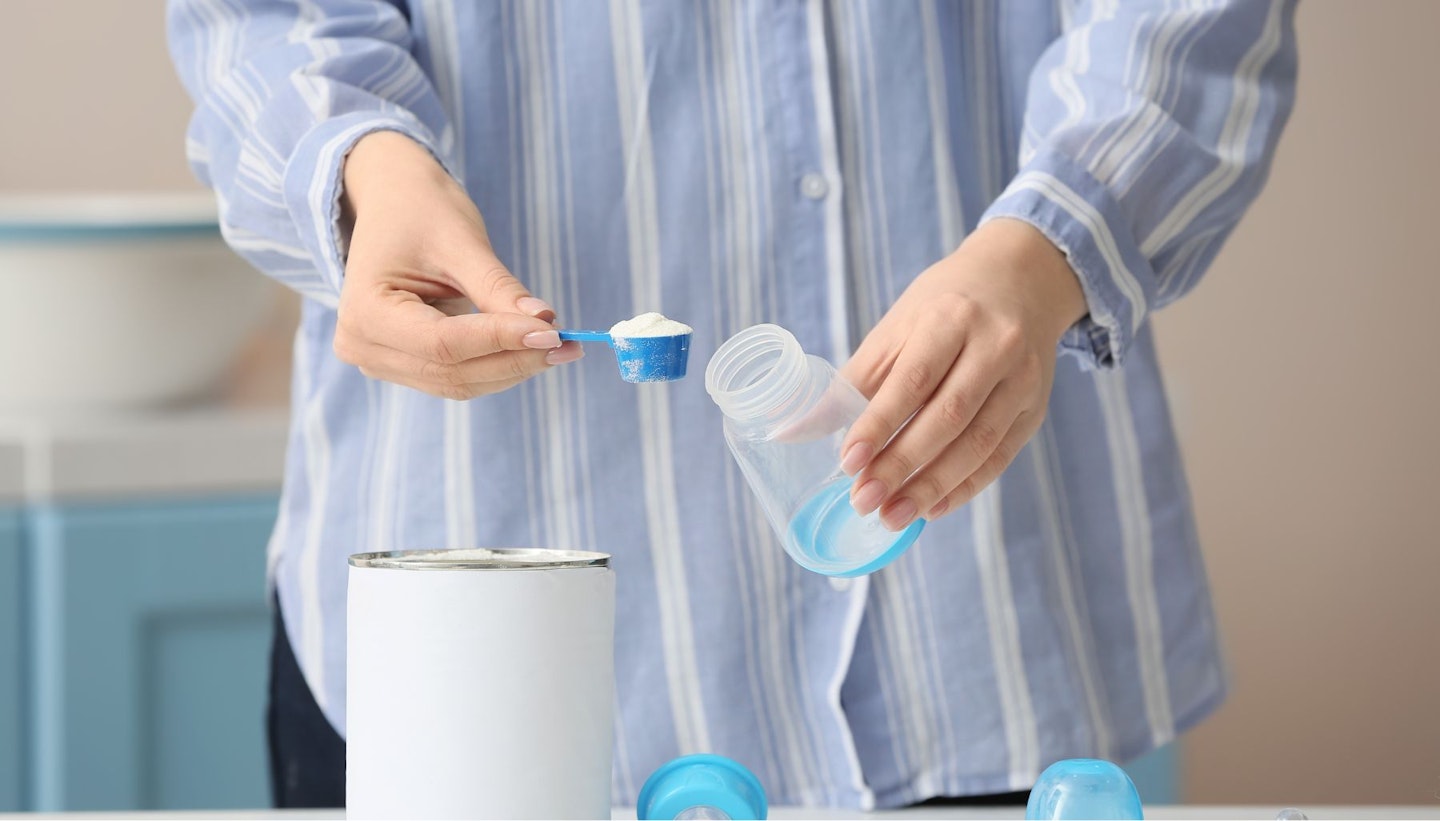 Woman Preparing Baby Milk Formula