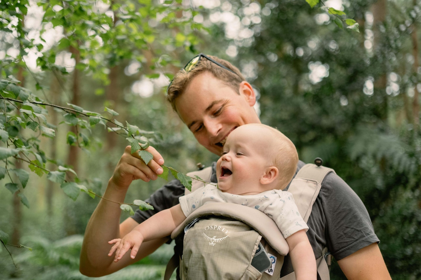 man and baby in woods with osprey carrier