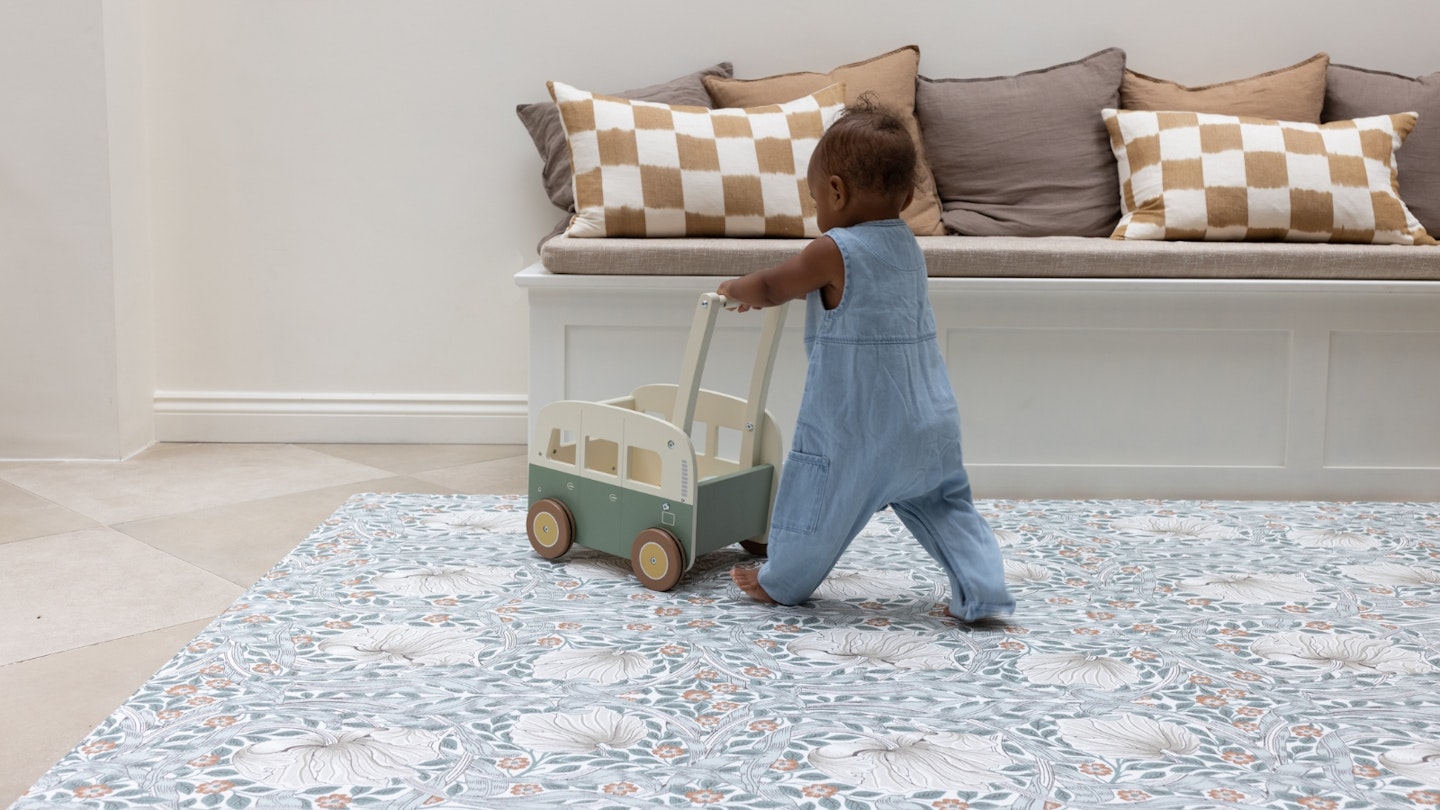 Totter+Tumble Lifestyle image of a baby playing on a playmat.