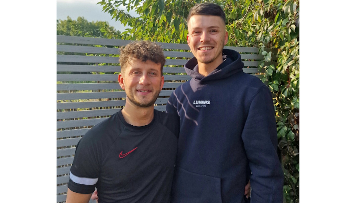 Foster parents Brandon and Adam pictured smiling