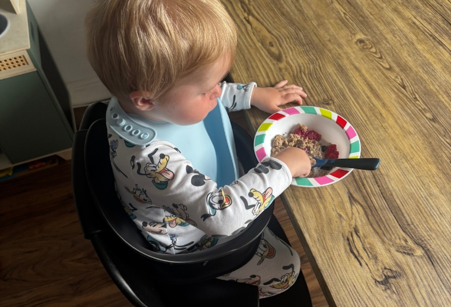 a young child eating in the Cybex Iris 3-in-1