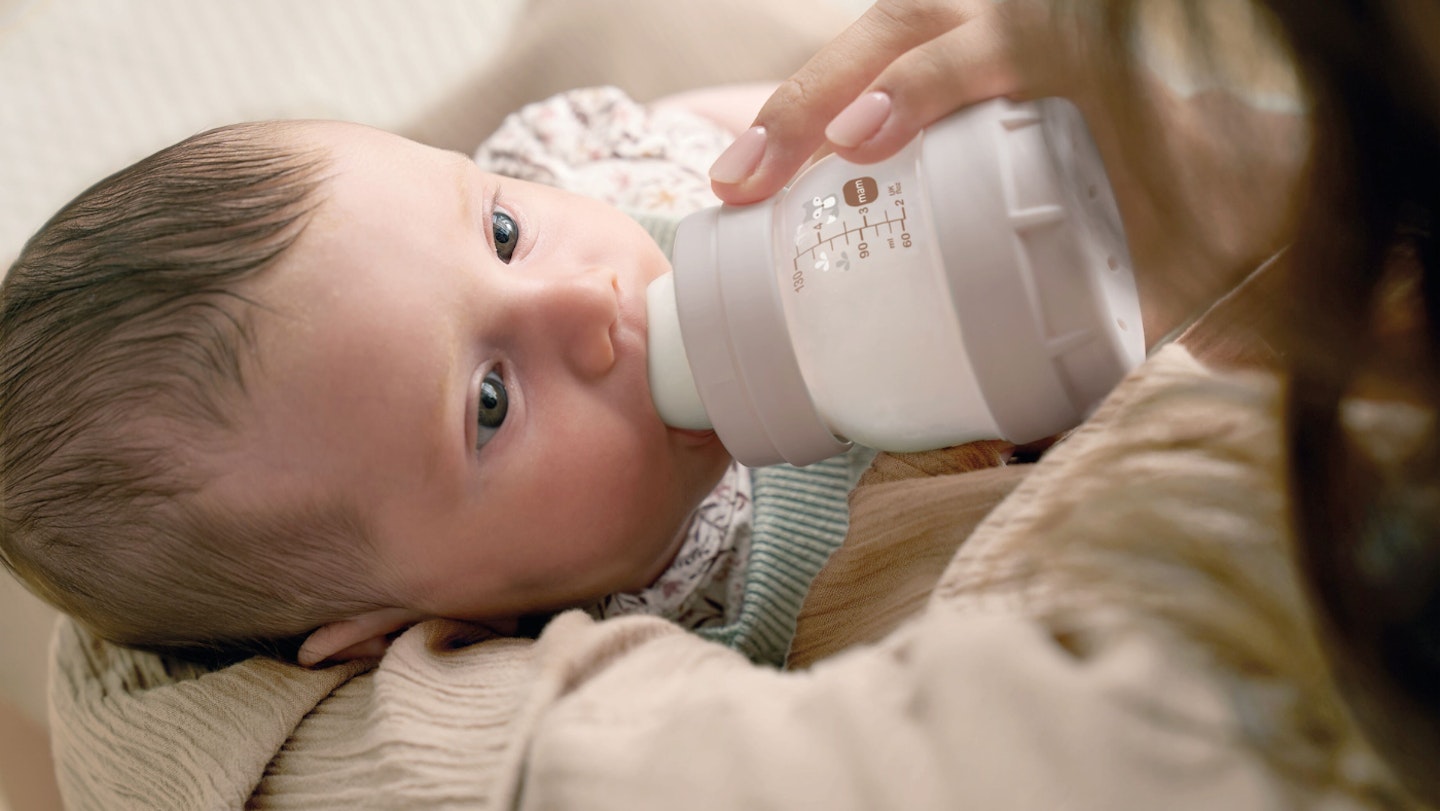 Baby feeding from MAM bottle