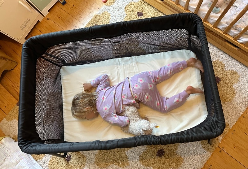 young child sleeping in the BabyBjorn Travel Cot Light