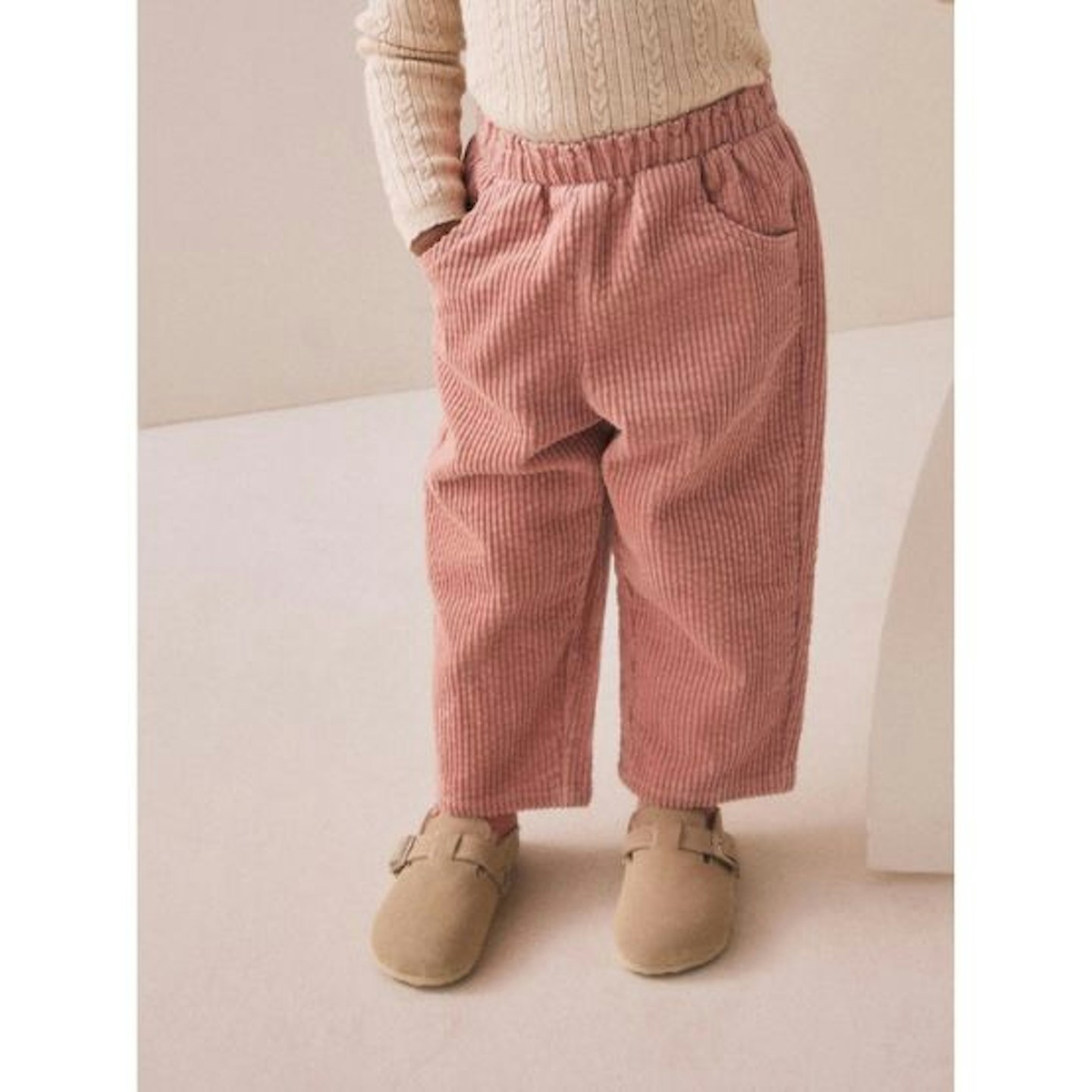 Child in pink cord trousers